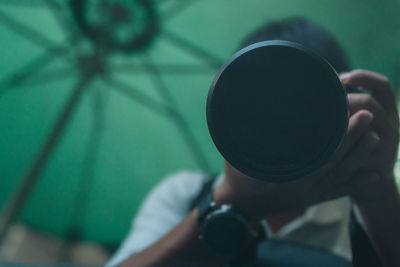 Close-up of man photographing camera