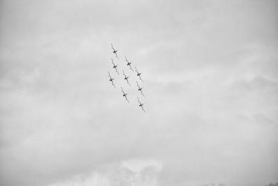 Low angle view of airplane flying against sky