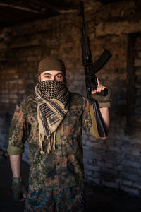 Portrait of serious middle eastern man with ak-47