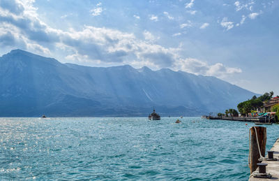 Scenic view of sea and mountains against sky