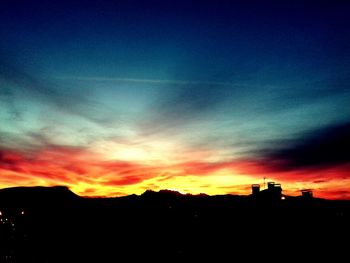 Silhouette of landscape against dramatic sky