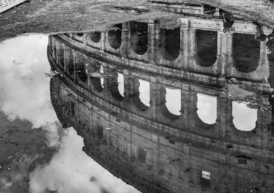 Reflection of building in puddle