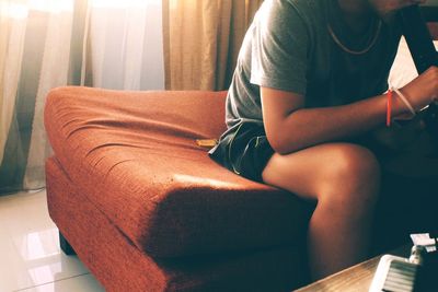 Woman relaxing on sofa at home