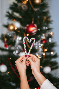 Midsection of woman with christmas tree