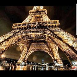 Low angle view of illuminated tower at night