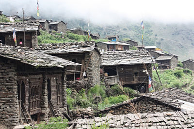 Old houses in village amidst buildings