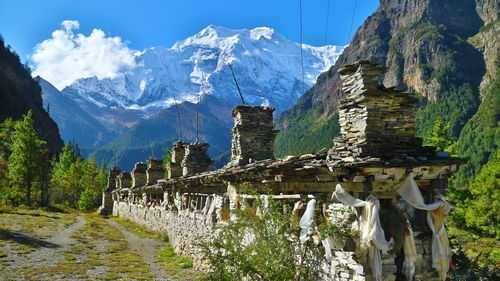 Panoramic shot of building and mountains against sky