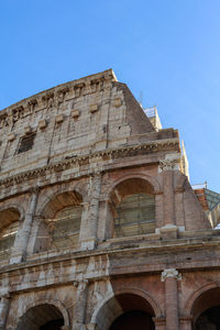 Low angle view of historical building against clear blue sky