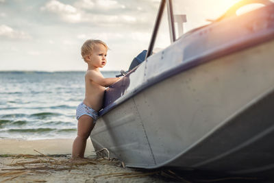 Full length of shirtless boy in sea