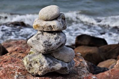 Close-up of stack of rocks at beach