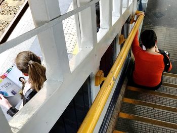 High angle view of woman sitting on floor