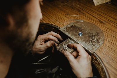 Midsection of man working on cutting board