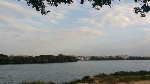 Scenic view of lake against cloudy sky