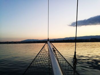 Bridge over river against sky during sunset