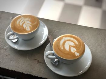 High angle view of cappuccinos on table