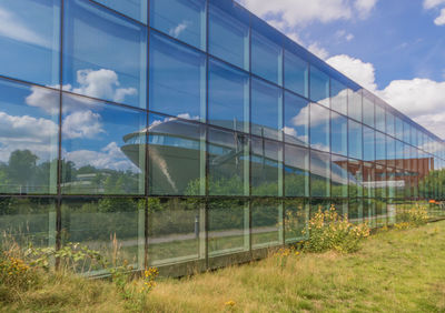 Reflection of sky on field seen through glass window