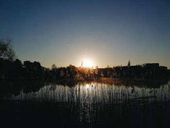 Scenic view of lake against sky during sunset