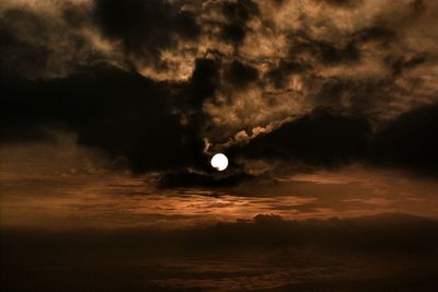 Full moon in cloudy sky