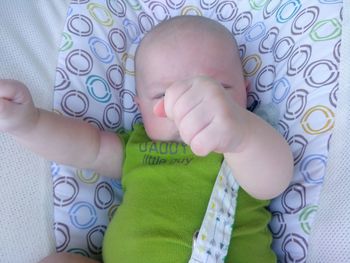 Low section of baby boy on bed