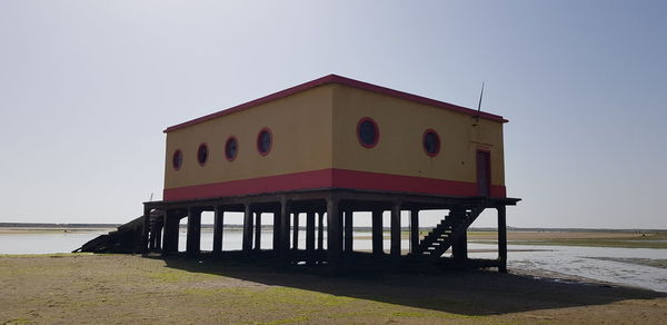 Lifeguard hut on beach against clear sky