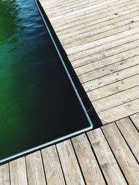 High angle view of boardwalk by swimming pool