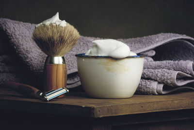 Close-up of shaving equipment on table