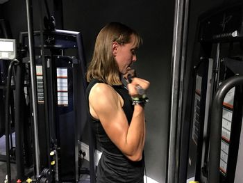 Side view of young woman standing at home