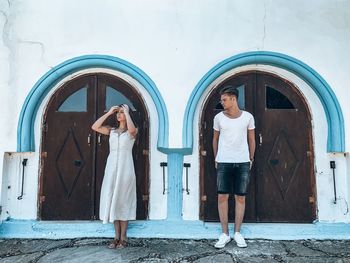 Woman standing by door of building