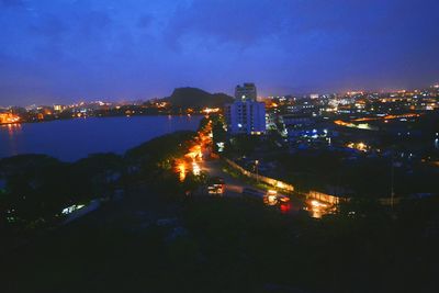 Aerial view of city lit up at night
