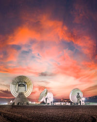 Rear view of man standing against sky during sunset