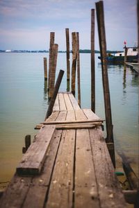 Wooden pier over lake against sky