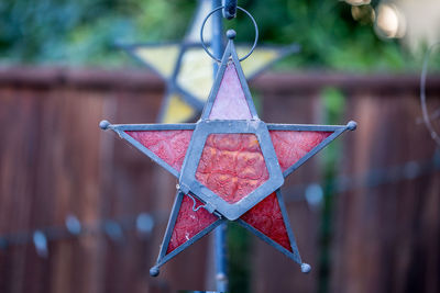 Close-up of red metal hanging on tree