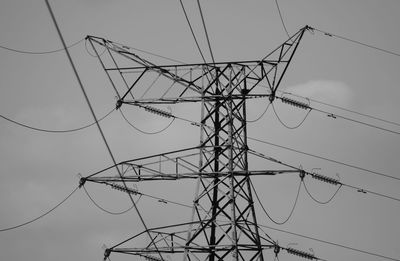 Low angle view of electricity pylon against clear sky