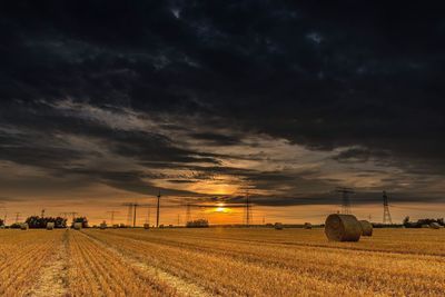 Scenic view of agricultural field against sky during sunset