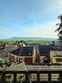 Houses in town against sky