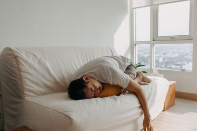 Man sleeping on bed at home