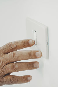 Close-up of hand against white background