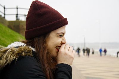 Close-up of smiling young woman at beach