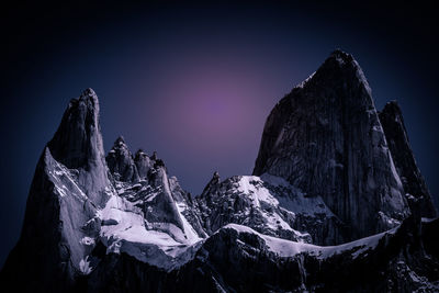 Panoramic view of snowcapped mountain against sky at night