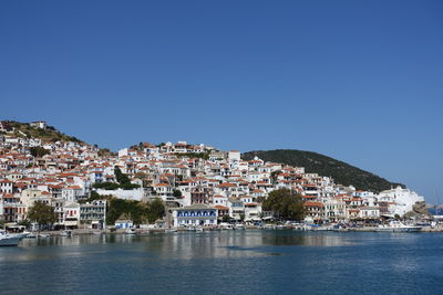 Town by sea against sky