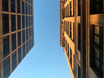 Low angle view of buildings against clear blue sky