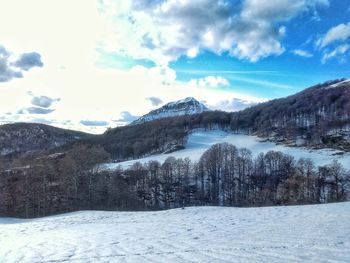 Scenic view of mountains against sky during winter