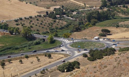 High angle view of vehicles on road amidst trees in city