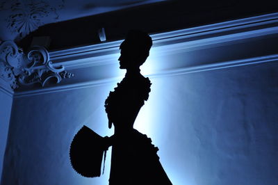 Low angle view of silhouette woman against sky