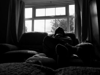 Woman sitting on chair at home