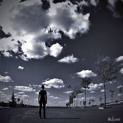 Silhouette of people against cloudy sky