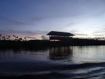 Scenic view of lake against sky at sunset