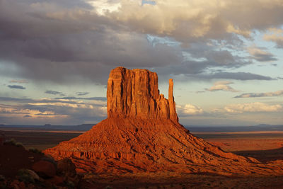 Rock formations on landscape against sky during sunset