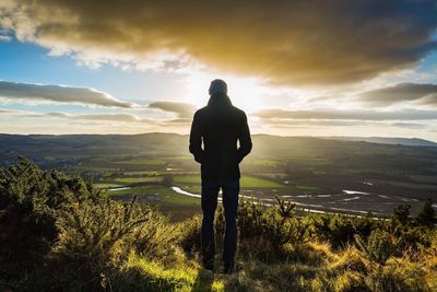 Portrait of man standing on landscape against sky