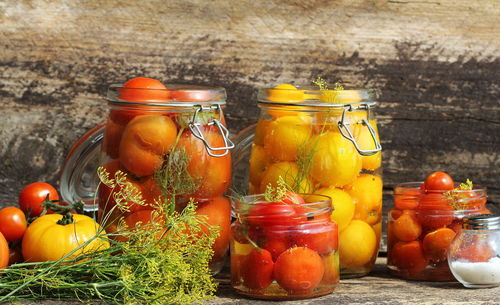 Fruits in glass jar on table